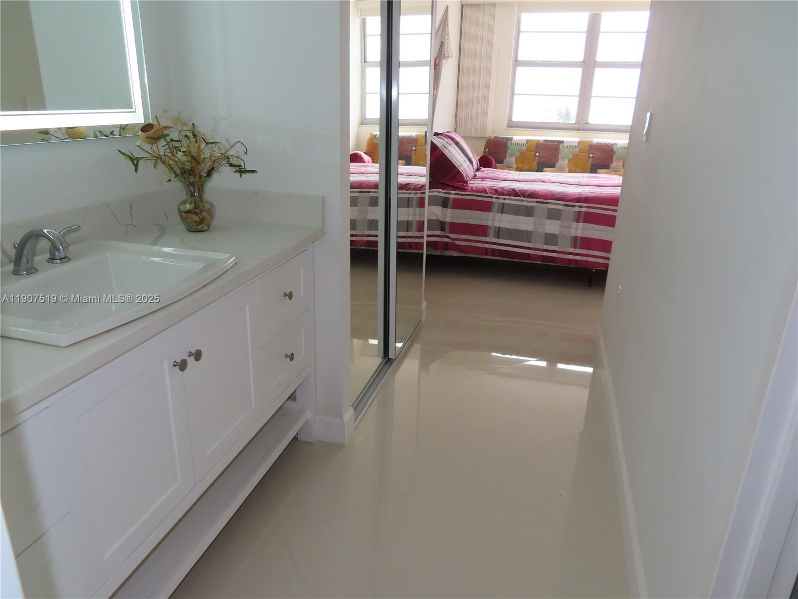 5701 Collins Avenue, Unit 304 Miami Beach, FL 33140 - Photo 16 of 42 a bathroom with a sink and a window