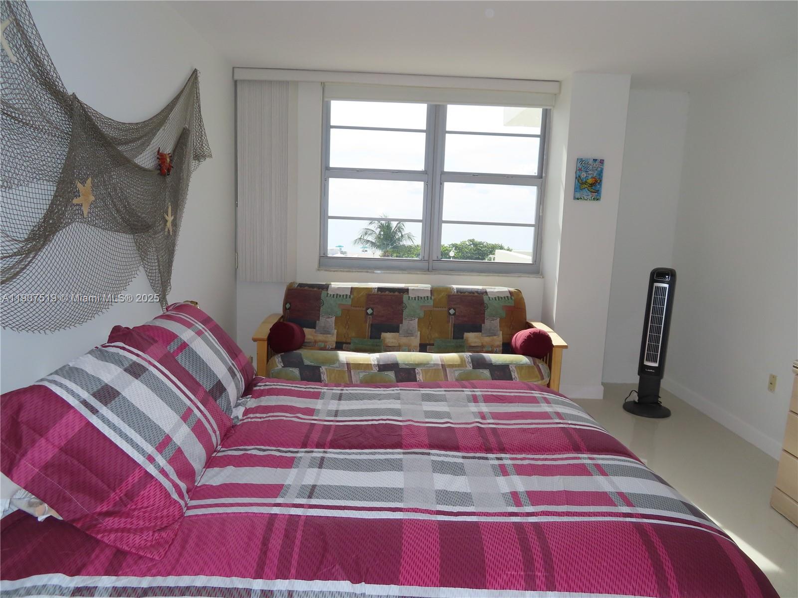 5701 Collins Avenue, Unit 304 Miami Beach, FL 33140 - Photo 17 of 42 a bedroom with a bed and wooden floor