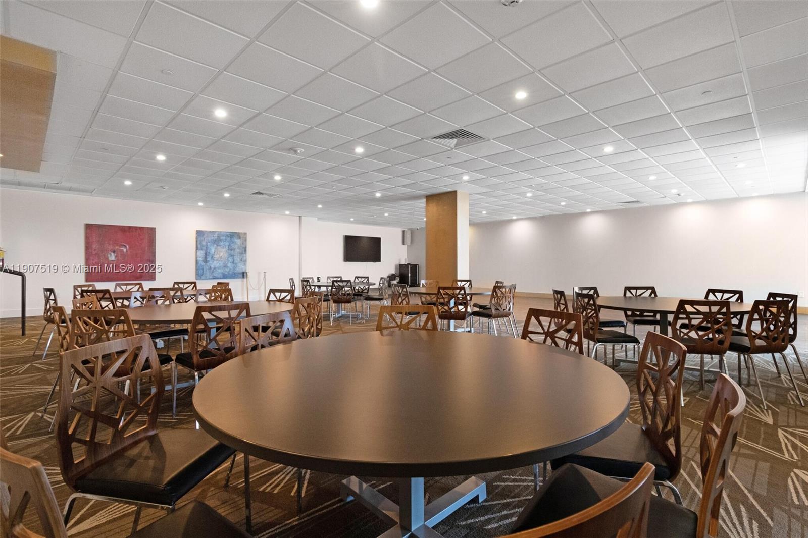 5701 Collins Avenue, Unit 304 Miami Beach, FL 33140 - Photo 39 of 42 a dining room with lots of chairs and a chandelier