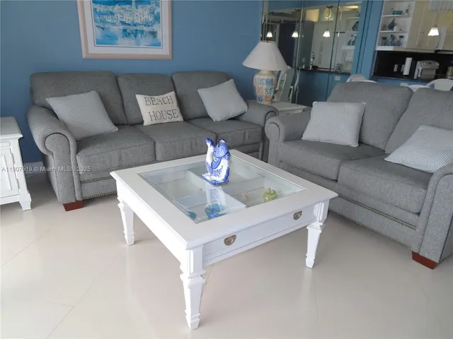 a kitchen with stainless steel appliances granite countertop a sink a refrigerator and a counter space