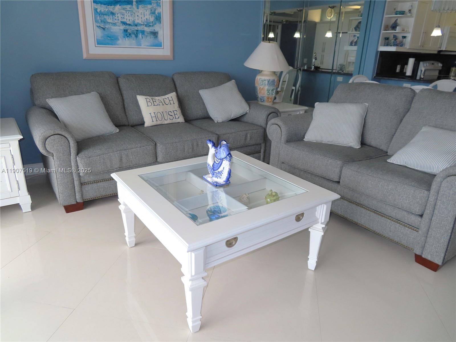 5701 Collins Avenue, Unit 304 Miami Beach, FL 33140 - Photo 8 of 42 a living room with furniture and a couch