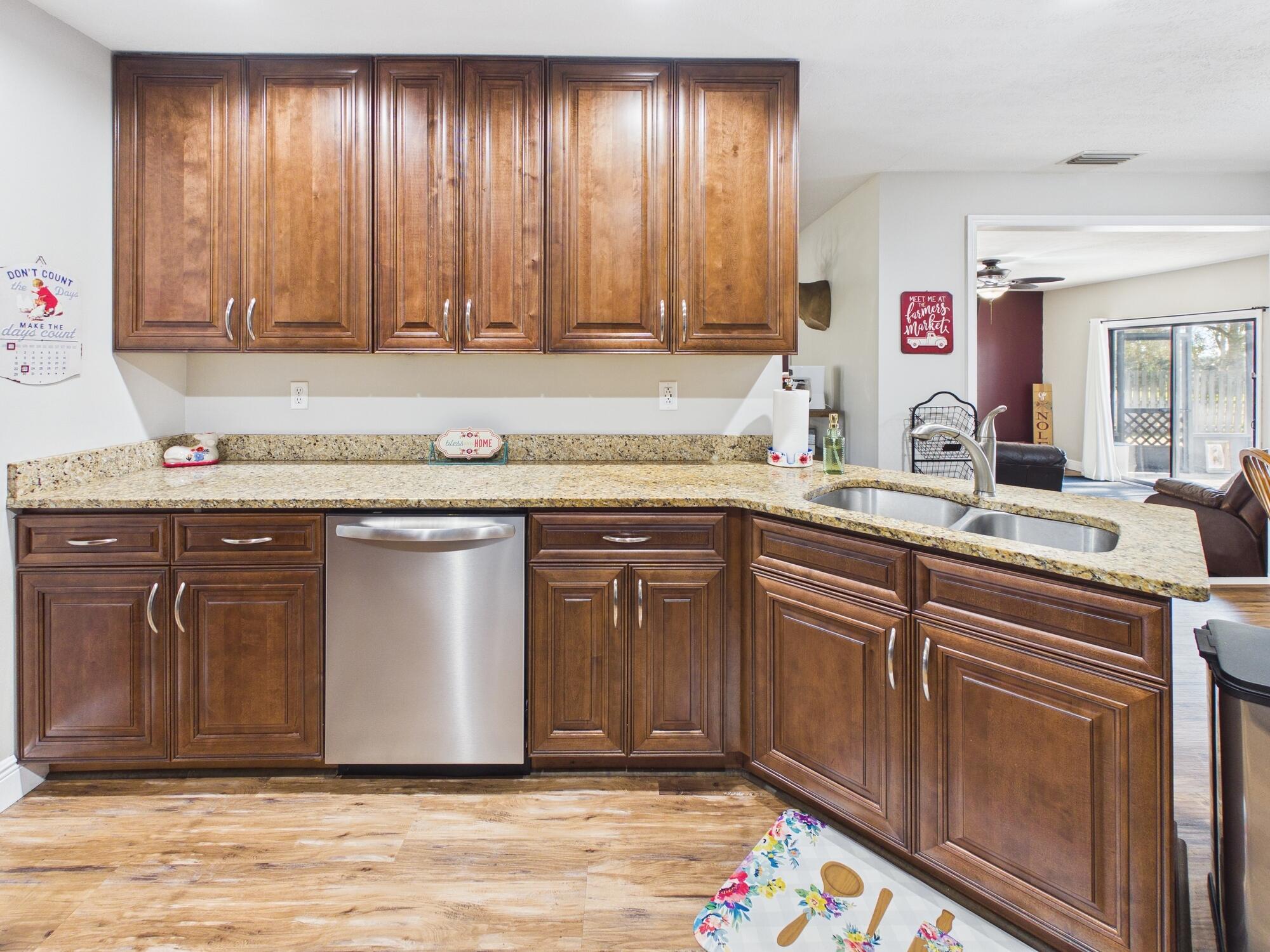 755 Southwest 85th Avenue Okeechobee, FL 34974 - Photo 20 of 99 a sink with granite countertop cabinets and window