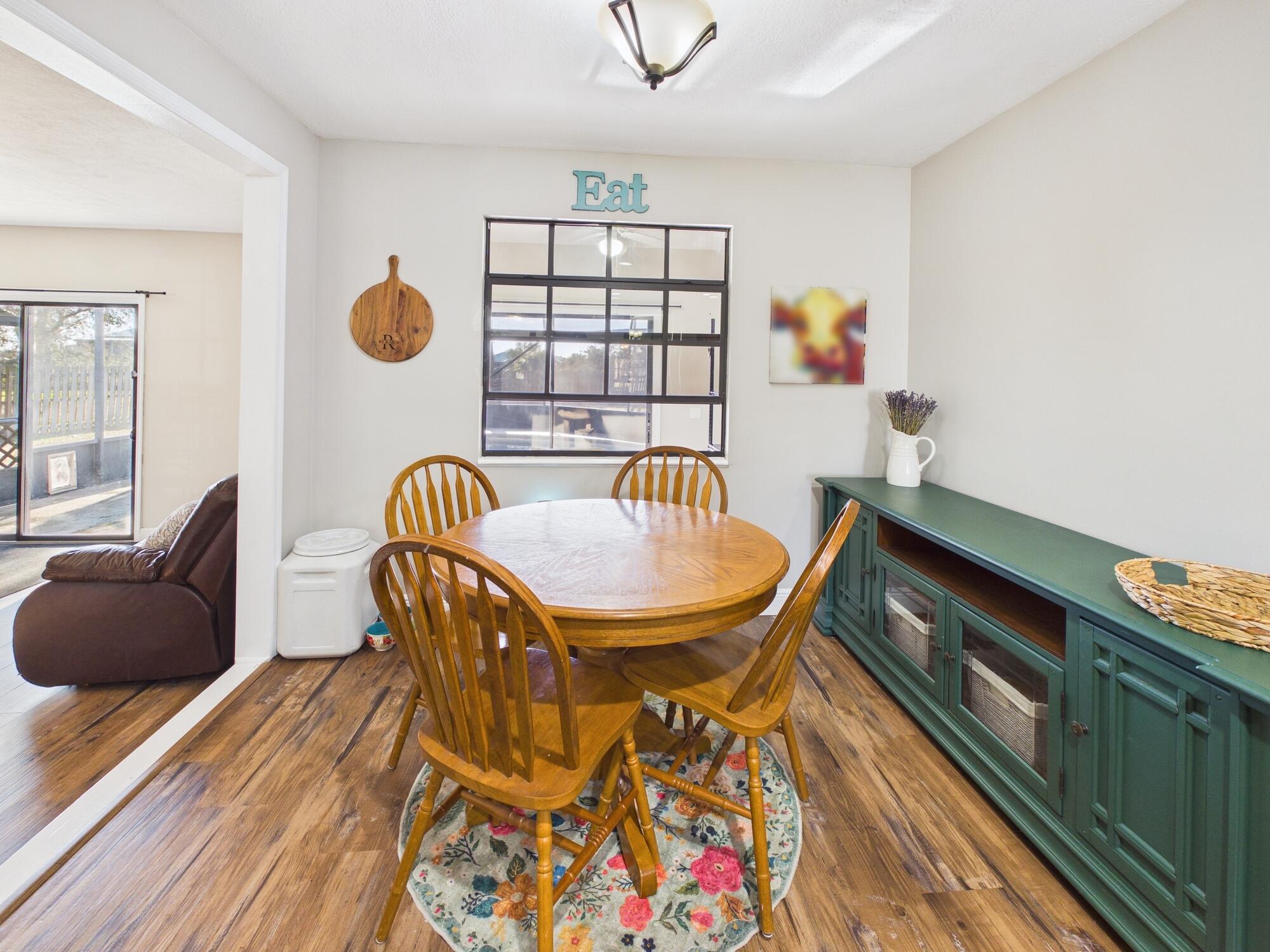 755 Southwest 85th Avenue Okeechobee, FL 34974 - Photo 23 of 99 a view of a dining room with furniture and wooden floor