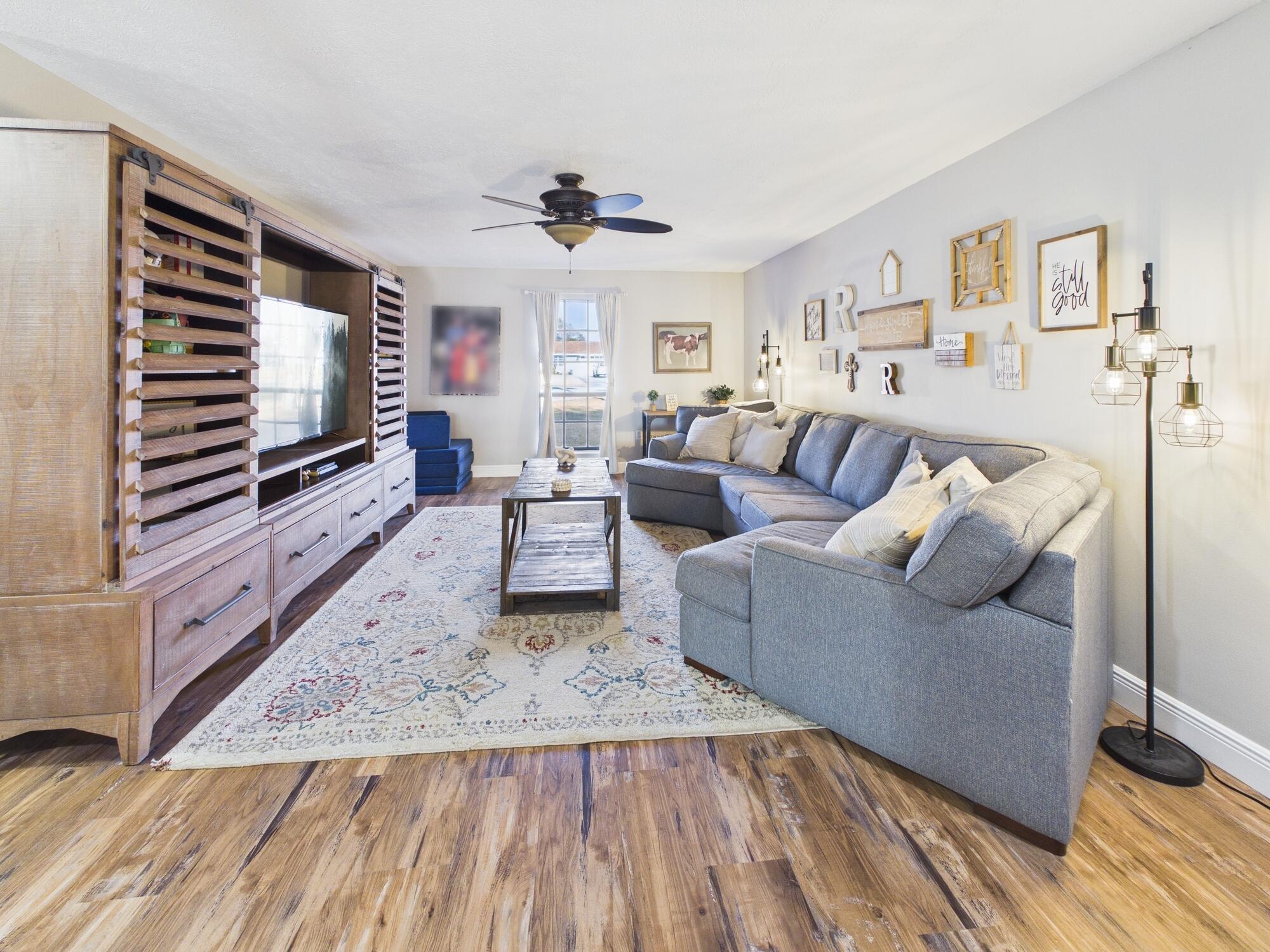 755 Southwest 85th Avenue Okeechobee, FL 34974 - Photo 28 of 99 a living room with furniture and a flat screen tv