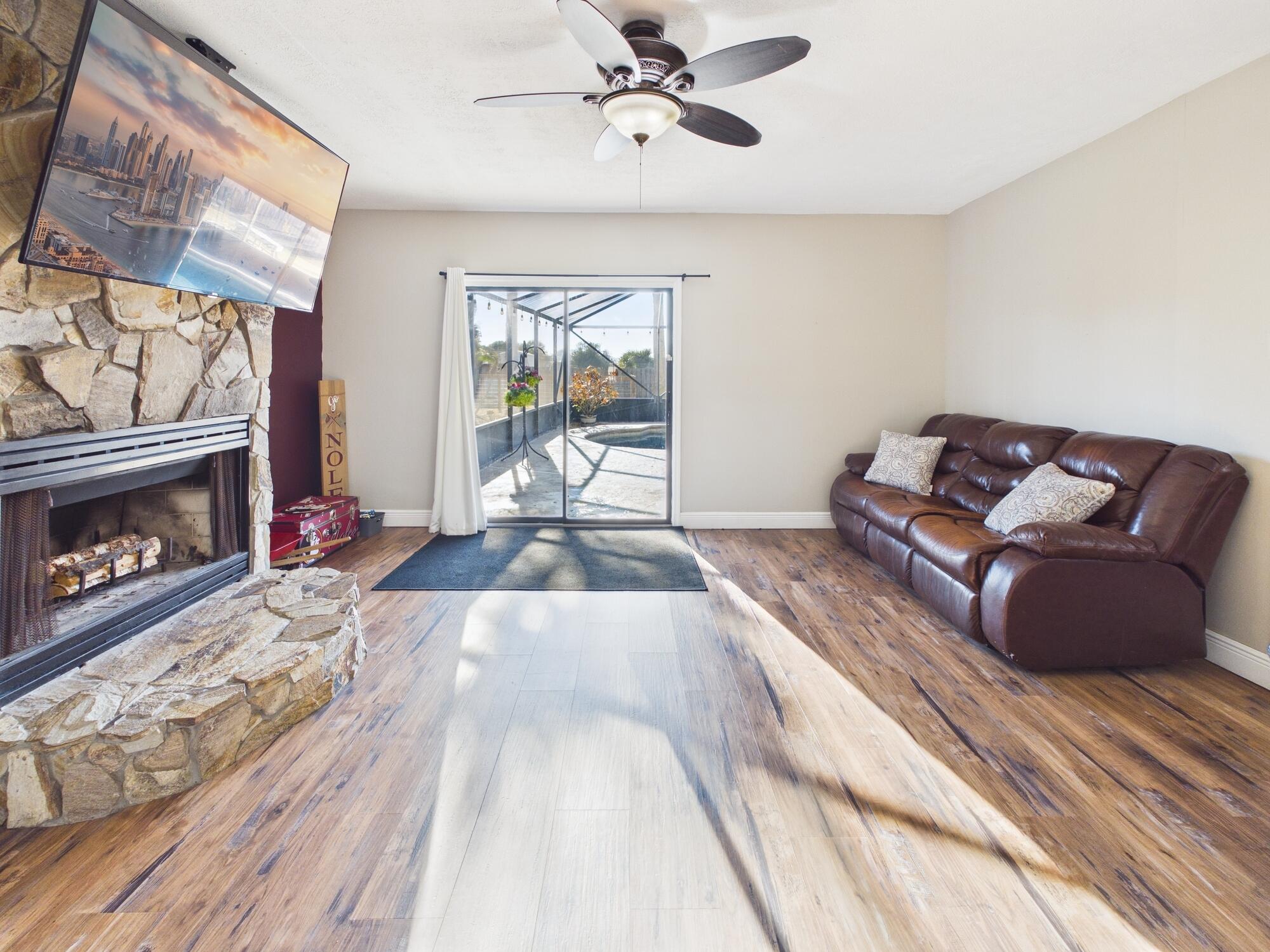 755 Southwest 85th Avenue Okeechobee, FL 34974 - Photo 37 of 99 a living room with furniture and a fireplace