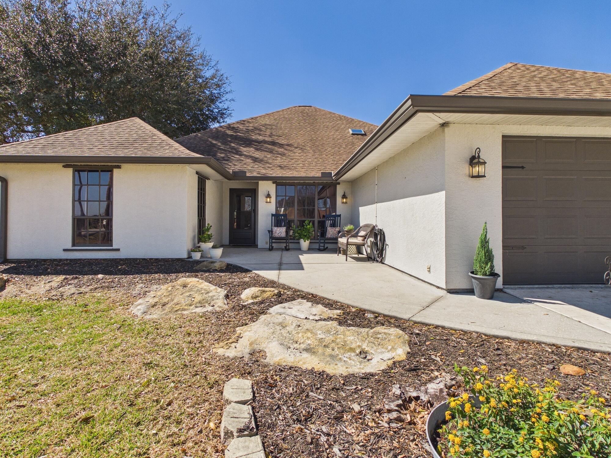 755 Southwest 85th Avenue Okeechobee, FL 34974 - Photo 5 of 99 a view of a white house with a yard