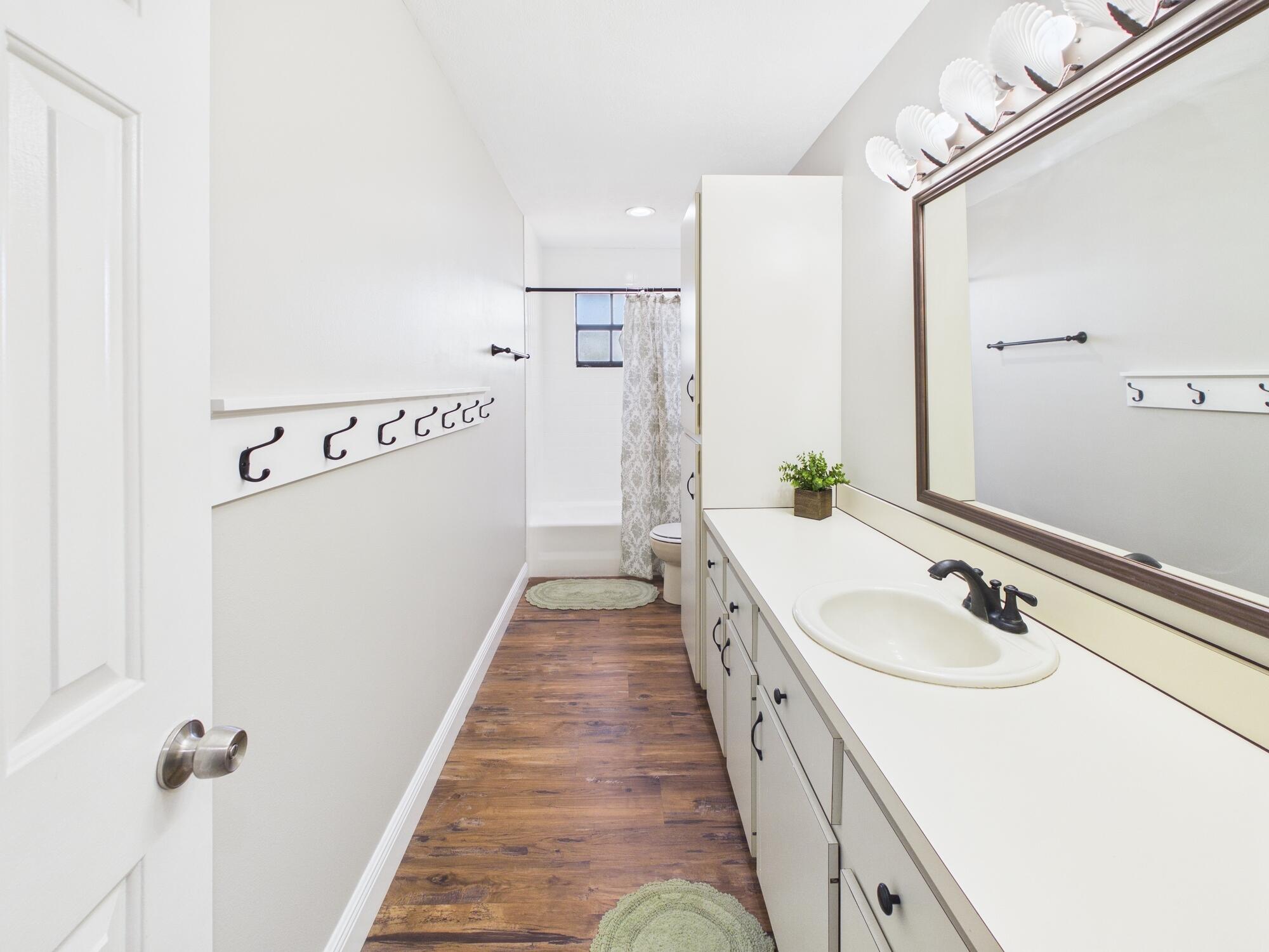 755 Southwest 85th Avenue Okeechobee, FL 34974 - Photo 63 of 99 a bathroom with a double vanity sink and mirror
