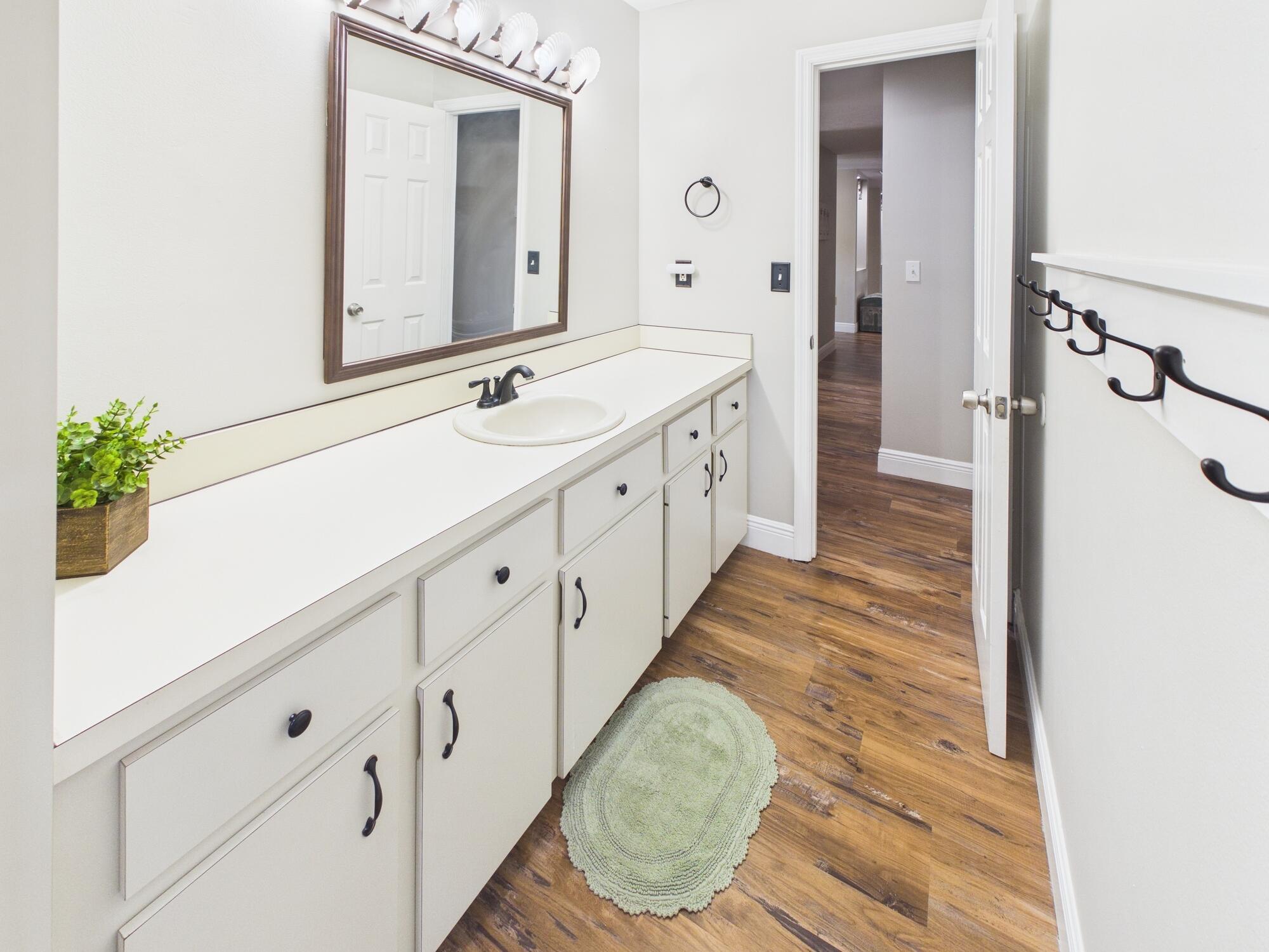 755 Southwest 85th Avenue Okeechobee, FL 34974 - Photo 65 of 99 a spacious bathroom with a double vanity sink and a mirror