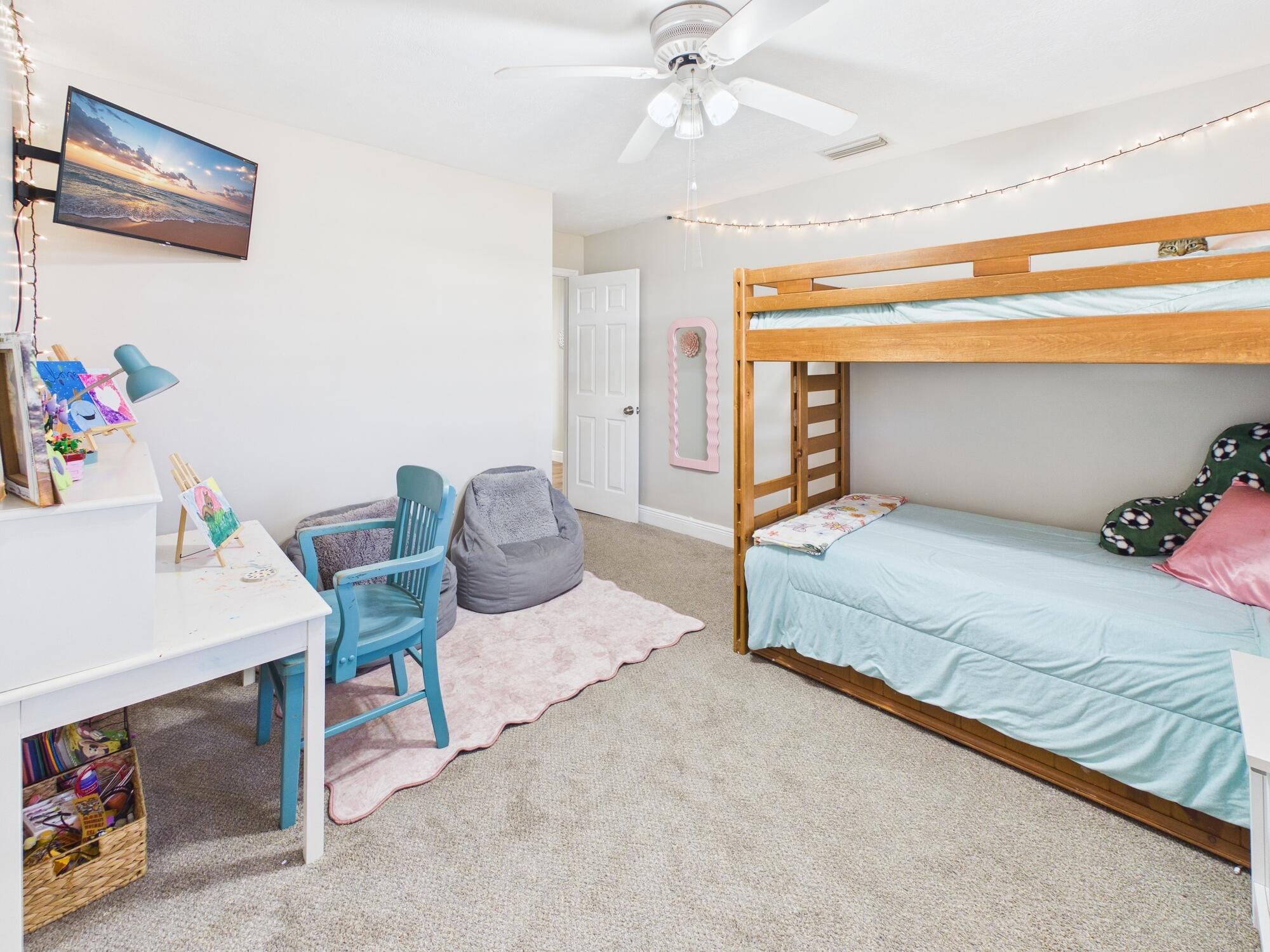 755 Southwest 85th Avenue Okeechobee, FL 34974 - Photo 67 of 99 a bedroom with a bed and a chandelier