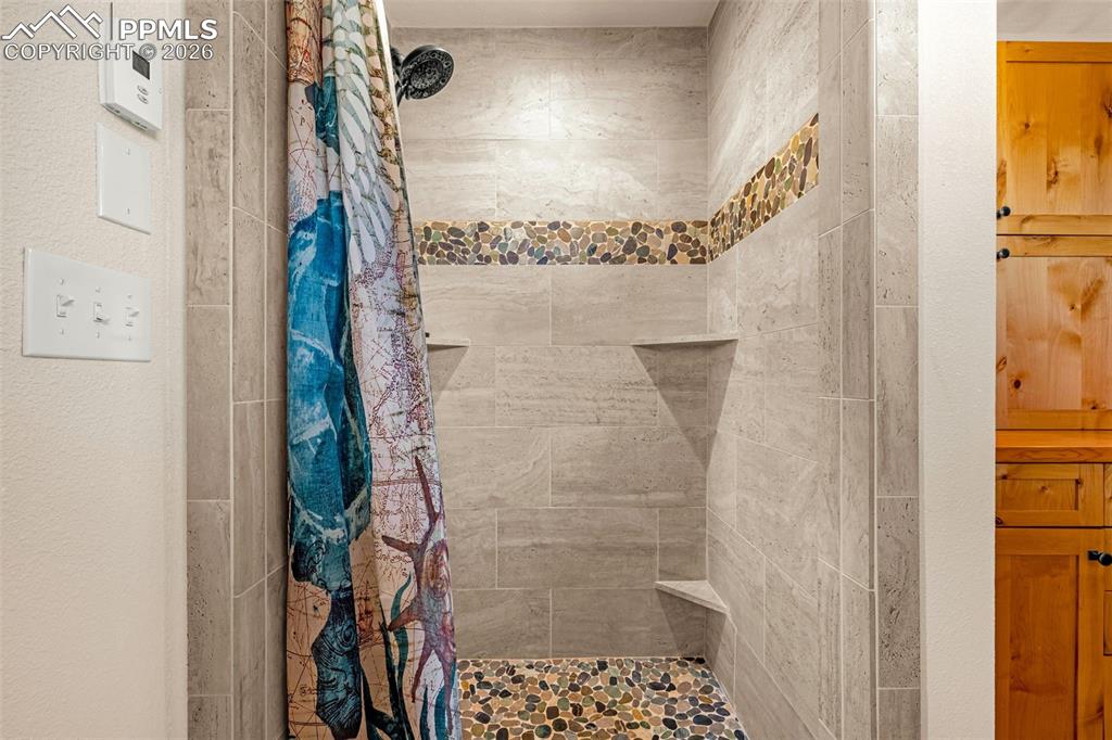 8480 Delaware Road Colorado Springs, CO 80926 - Photo 17 of 49 Bathroom featuring a shower stall