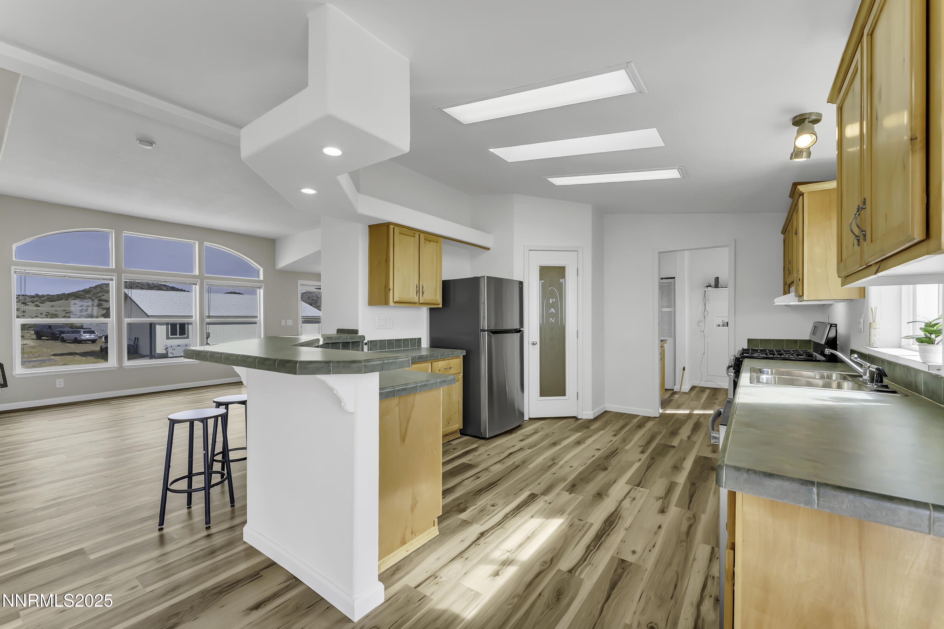 90 Curnow Canyon Road Reno, NV 89510 - Photo 12 of 63 a kitchen with granite countertop a sink stove and refrigerator