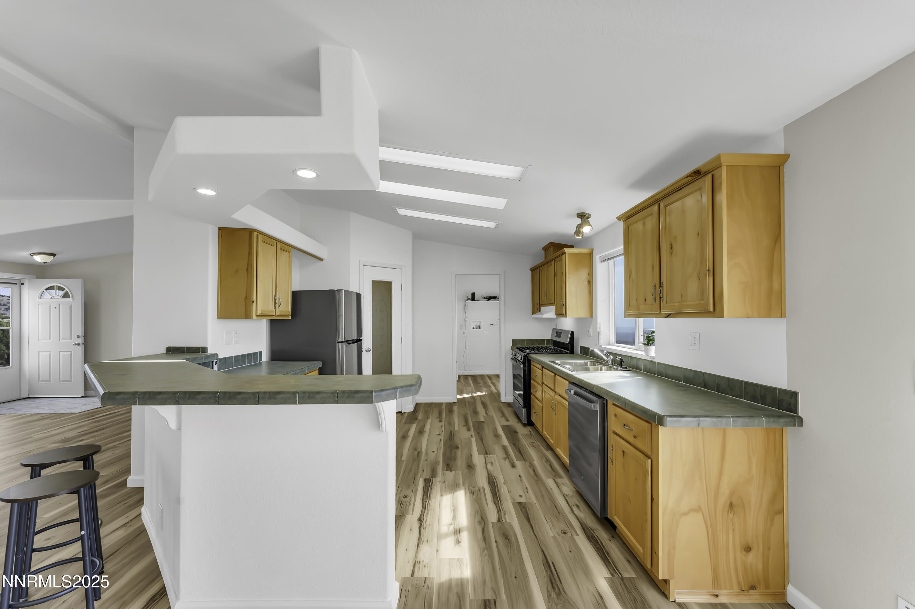 90 Curnow Canyon Road Reno, NV 89510 - Photo 13 of 63 a kitchen with stainless steel appliances granite countertop a sink stove and cabinets