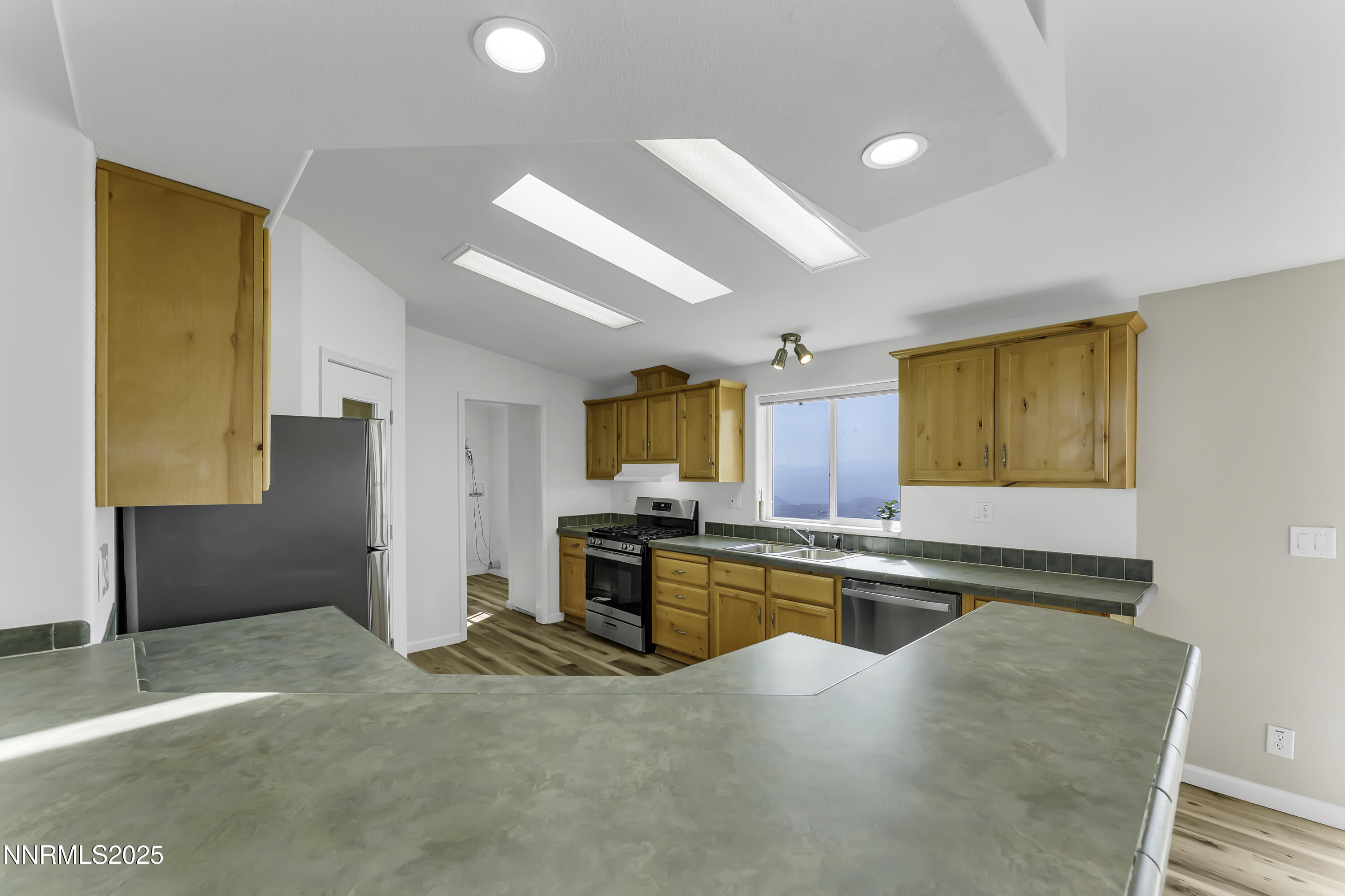 90 Curnow Canyon Road Reno, NV 89510 - Photo 14 of 63 a kitchen with stainless steel appliances granite countertop a sink and a refrigerator