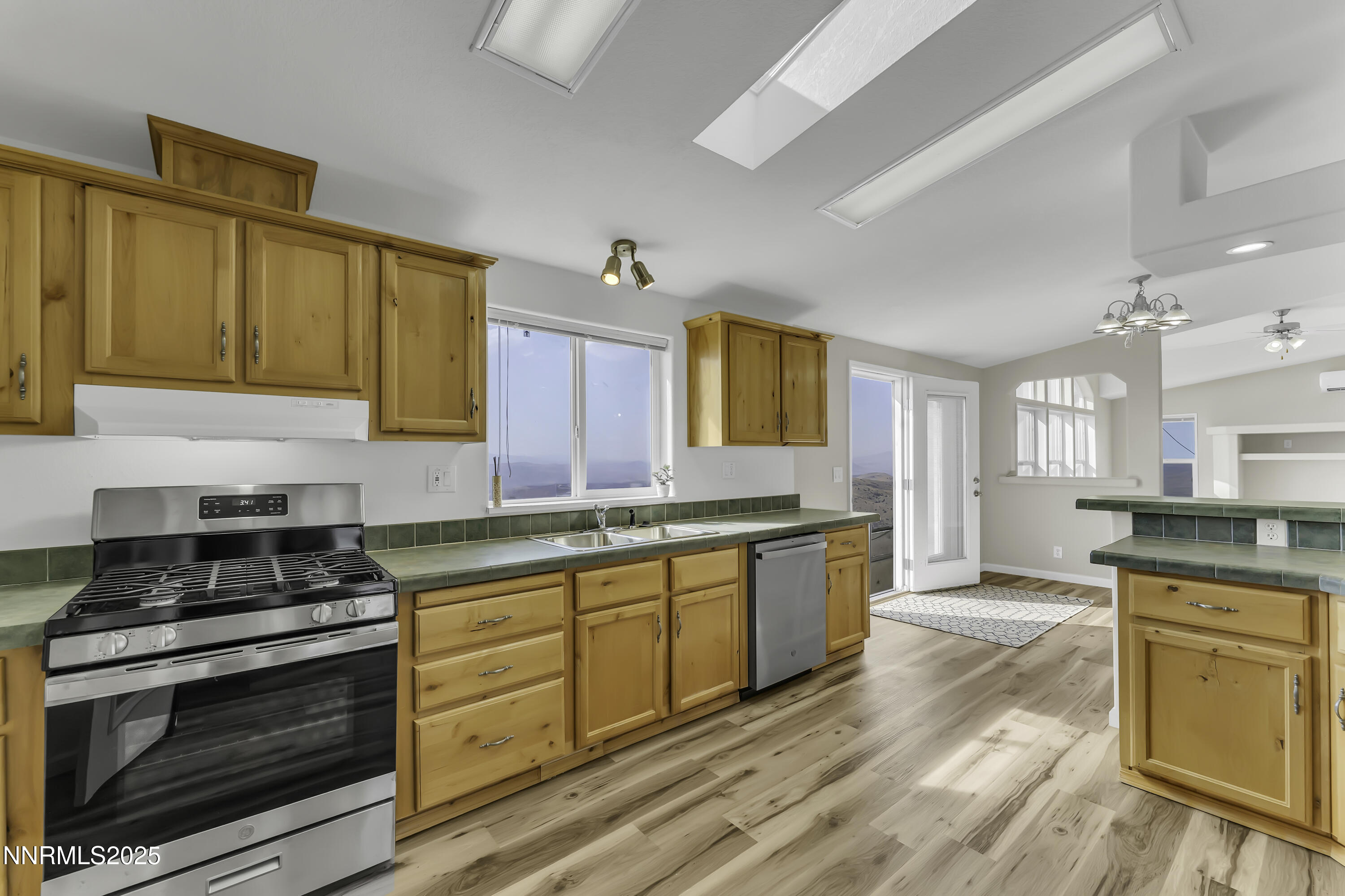 90 Curnow Canyon Road Reno, NV 89510 - Photo 15 of 63 a kitchen with stainless steel appliances granite countertop a stove and cabinets