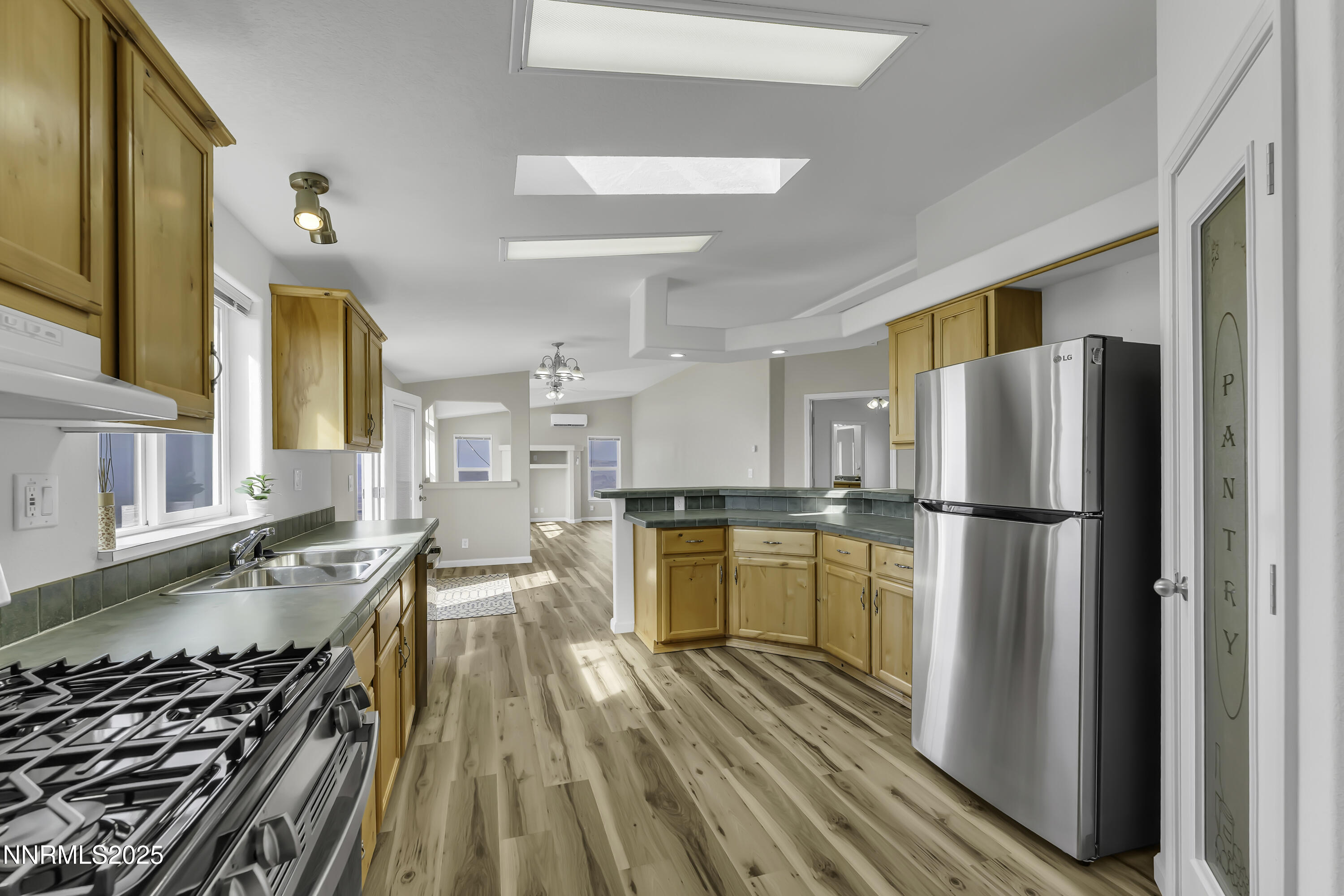 90 Curnow Canyon Road Reno, NV 89510 - Photo 16 of 63 a kitchen with a refrigerator and a stove top oven