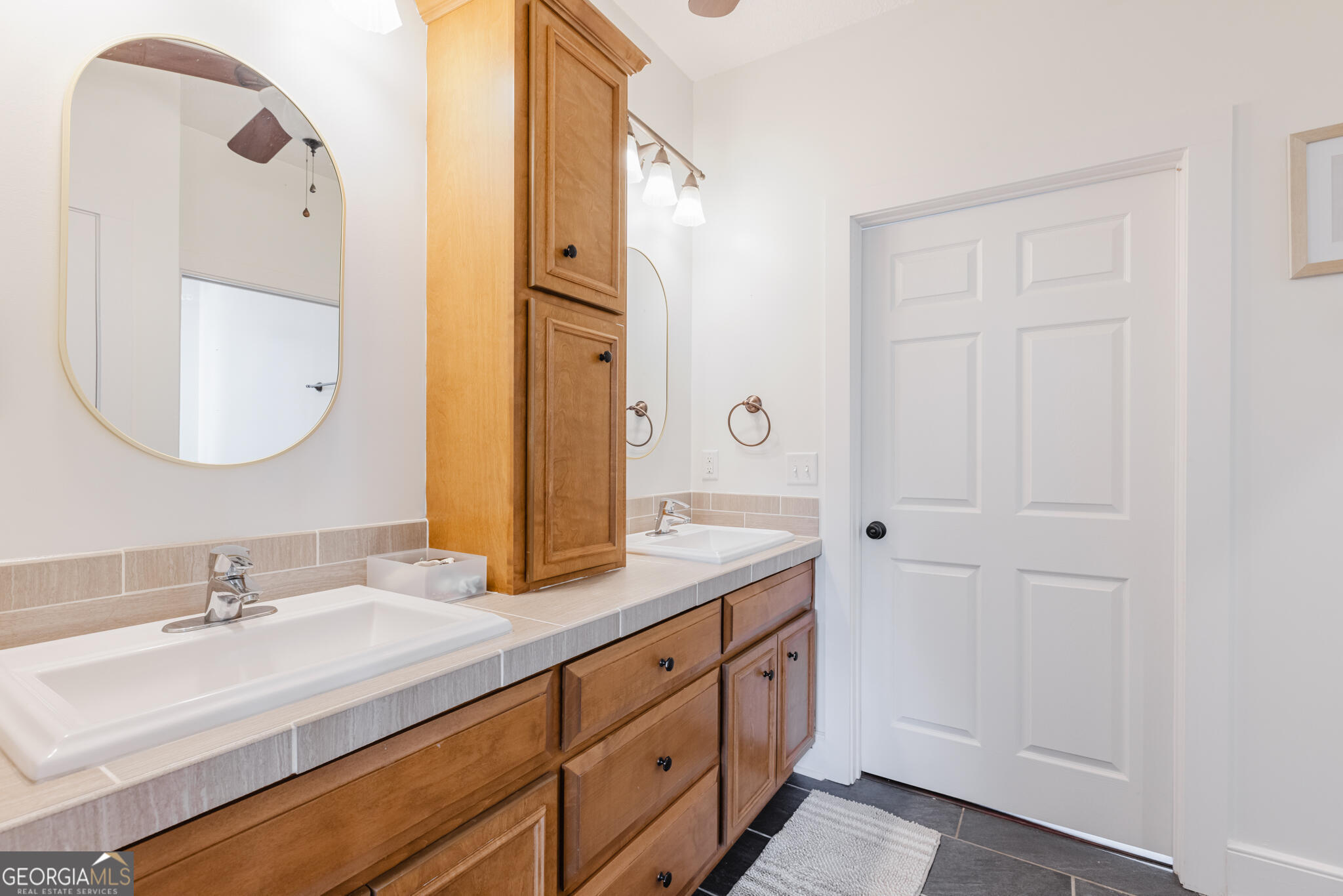 1859 Upper River Road Americus, GA 31709 - Photo 36 of 47 a bathroom with a double vanity sink and a mirror