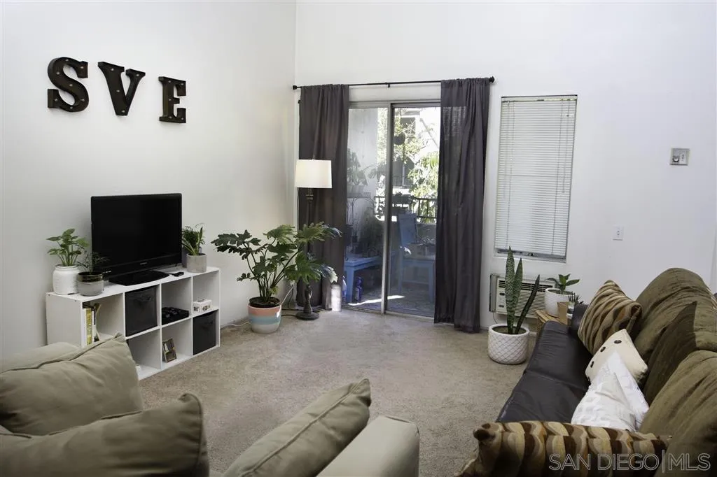 3583 Ruffin Road, Unit 214 San Diego, CA 92123 - Photo 2 of 12 a living room with furniture and a flat screen tv