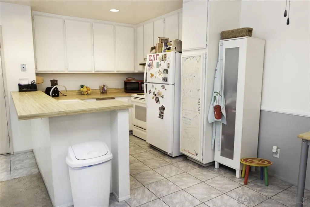 3583 Ruffin Road, Unit 214 San Diego, CA 92123 - Photo 3 of 12 a kitchen with a sink a refrigerator and a stove