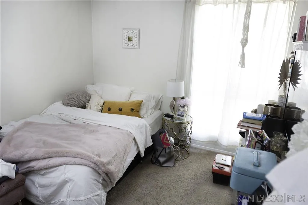 3583 Ruffin Road, Unit 214 San Diego, CA 92123 - Photo 7 of 12 a bedroom with a bed and a couch