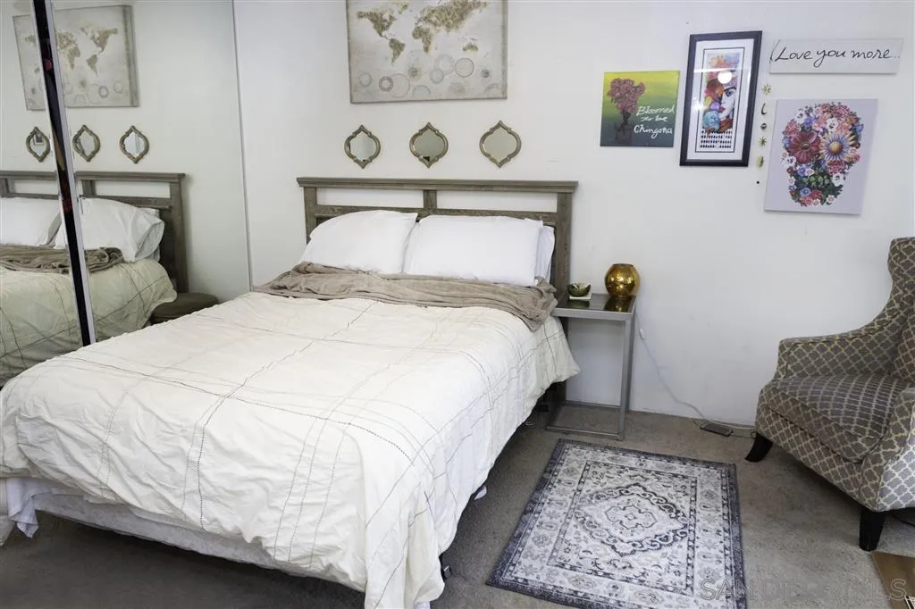 3583 Ruffin Road, Unit 214 San Diego, CA 92123 - Photo 9 of 12 a bed room with a bed and paintings on the wall