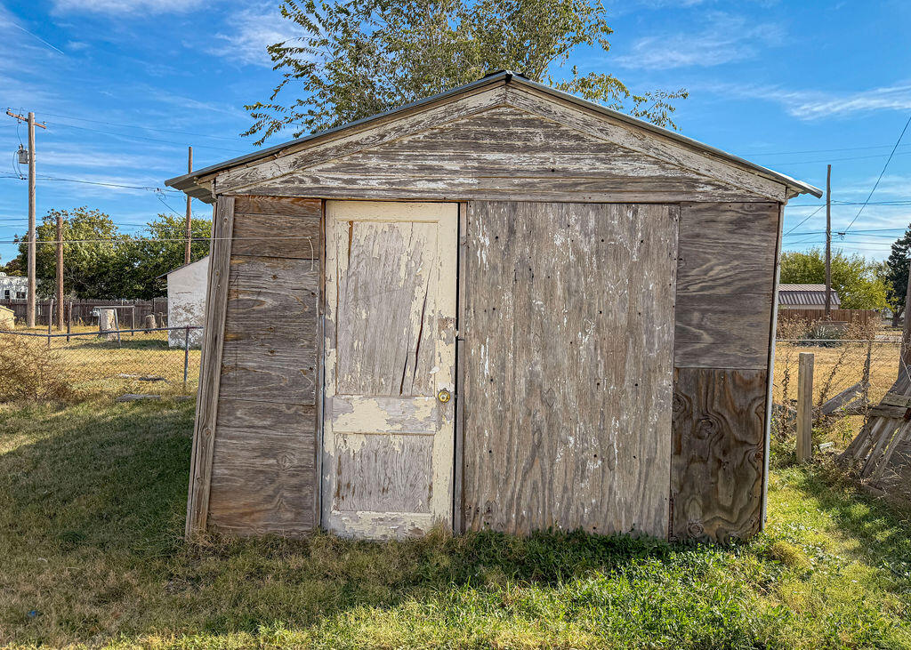 1204 Galveston Plainview, TX 79072 - Photo 12 of 12 a wooden door with a tree in the background