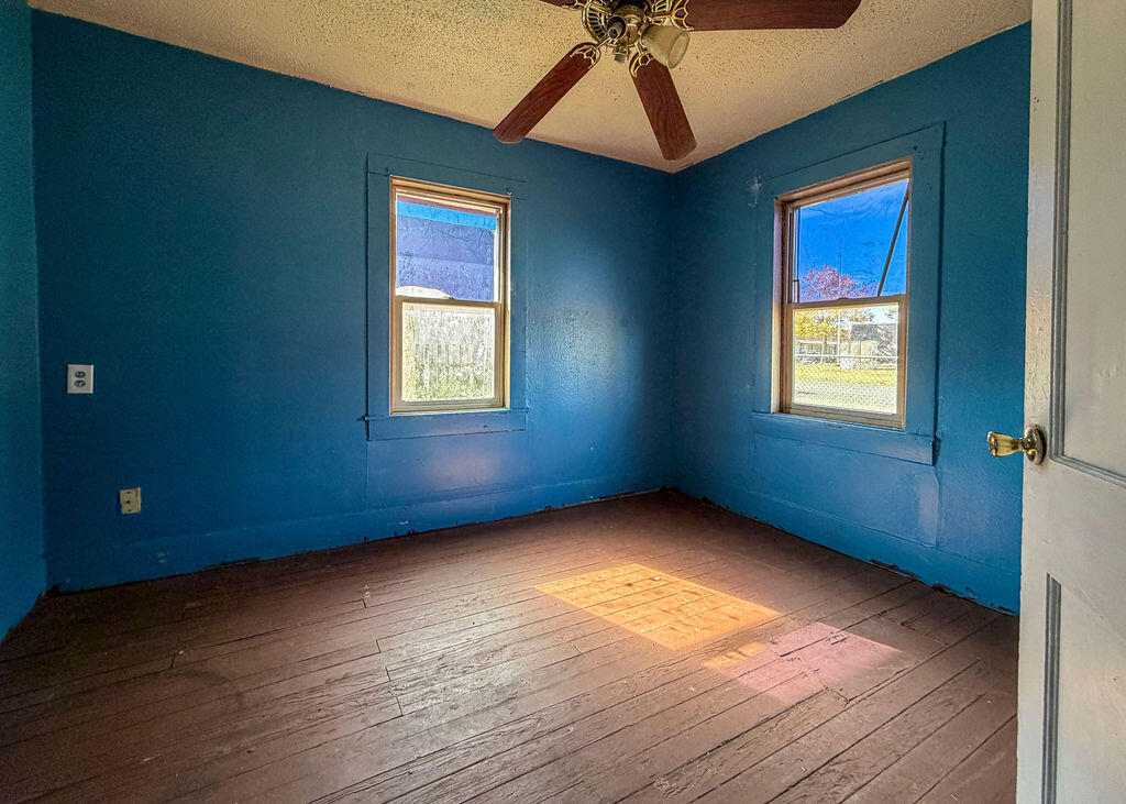 1204 Galveston Plainview, TX 79072 - Photo 5 of 12 a view of an empty room with window and wooden floor
