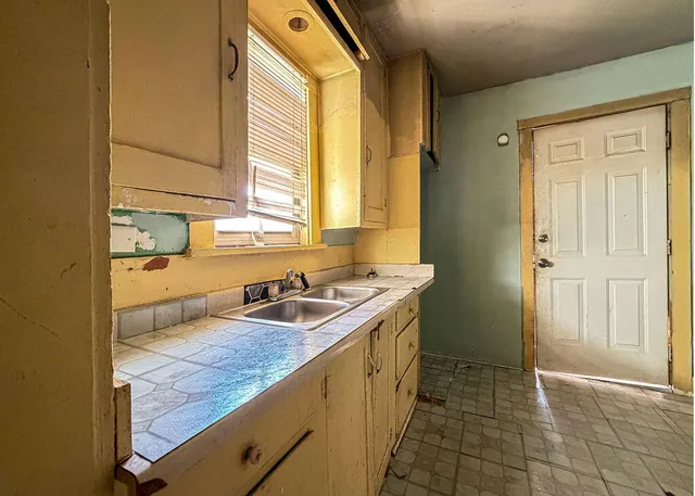 a kitchen with a sink and a refrigerator