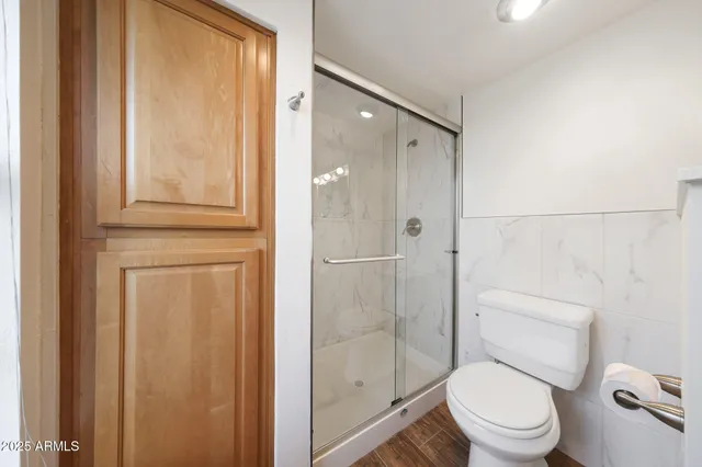 a white toilet sitting next to a bathroom sink
