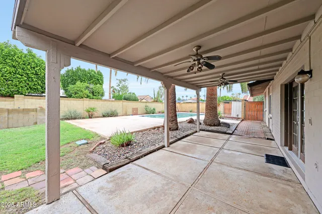 a view of swimming pool with a couches in patio