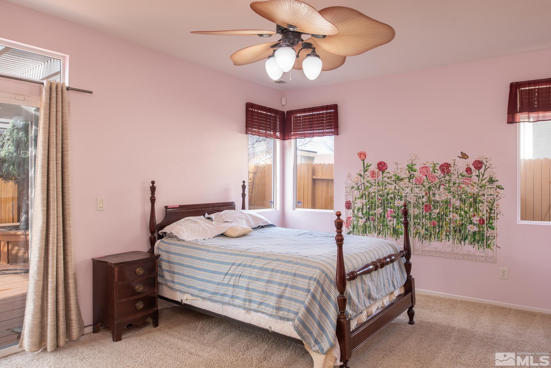 10175 Donner Peak Drive Reno, NV 89521 - Photo 18 of 35 a bedroom with a bed and a chandelier