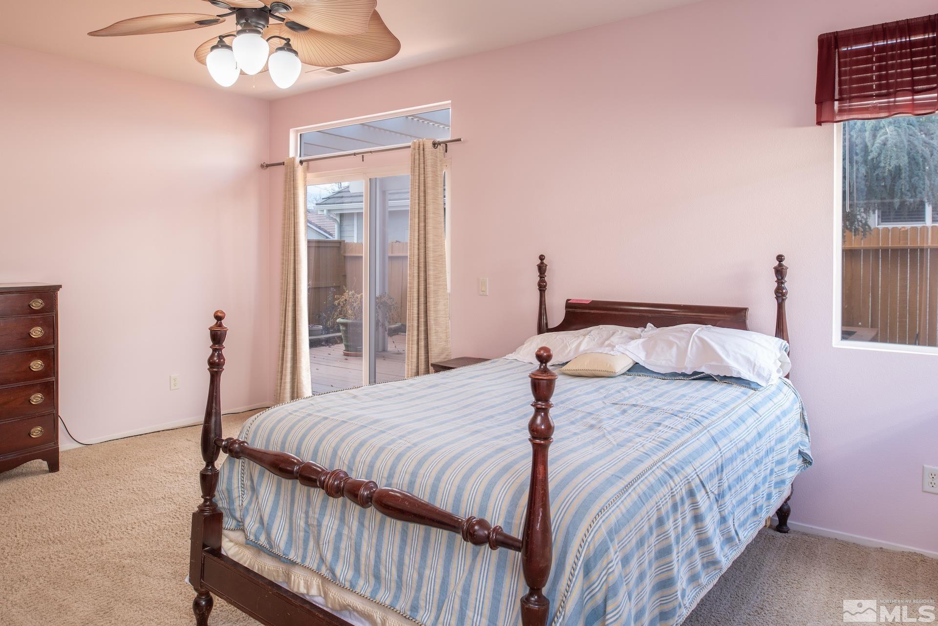 10175 Donner Peak Drive Reno, NV 89521 - Photo 19 of 35 a bedroom with a bed and a chandelier