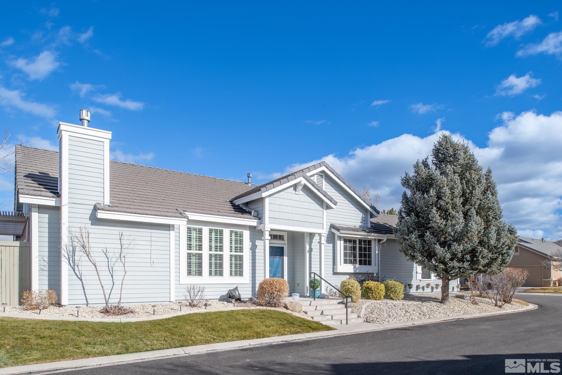10175 Donner Peak Drive Reno, NV 89521 - Photo 2 of 35 a front view of a house with a yard