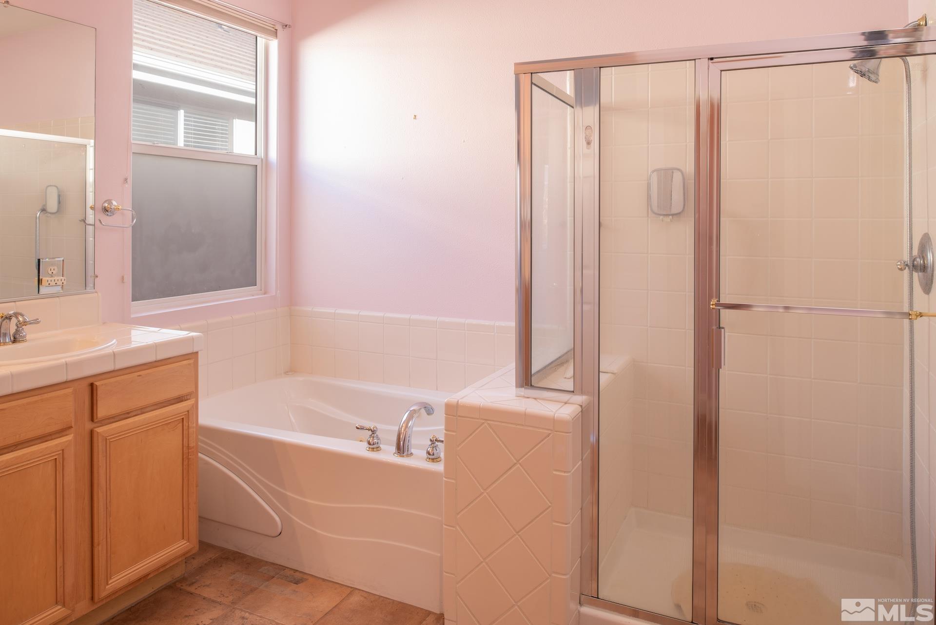 10175 Donner Peak Drive Reno, NV 89521 - Photo 22 of 35 a bathroom with a bathtub and a shower
