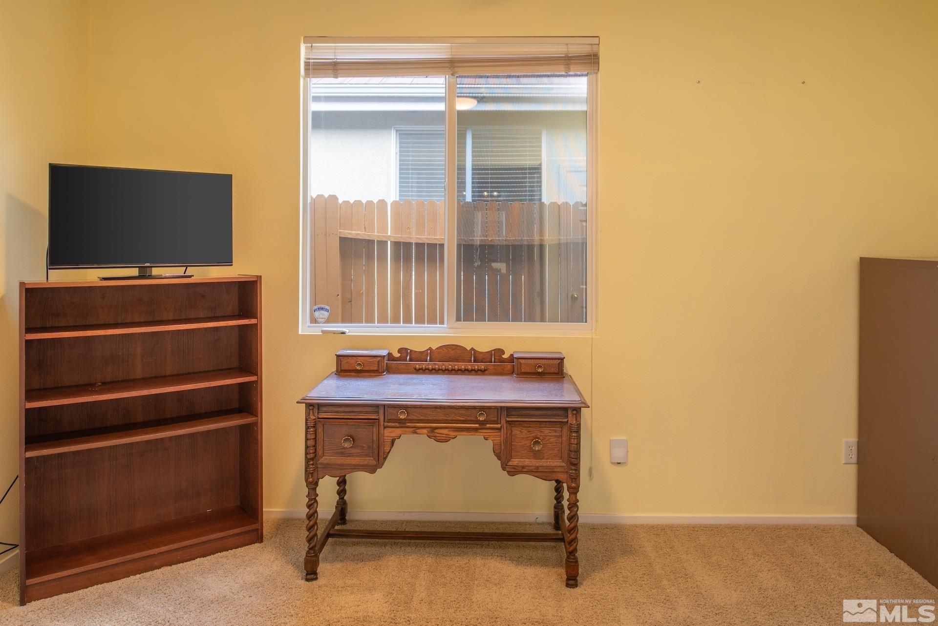 10175 Donner Peak Drive Reno, NV 89521 - Photo 23 of 35 a living room with a furniture and a flat screen tv