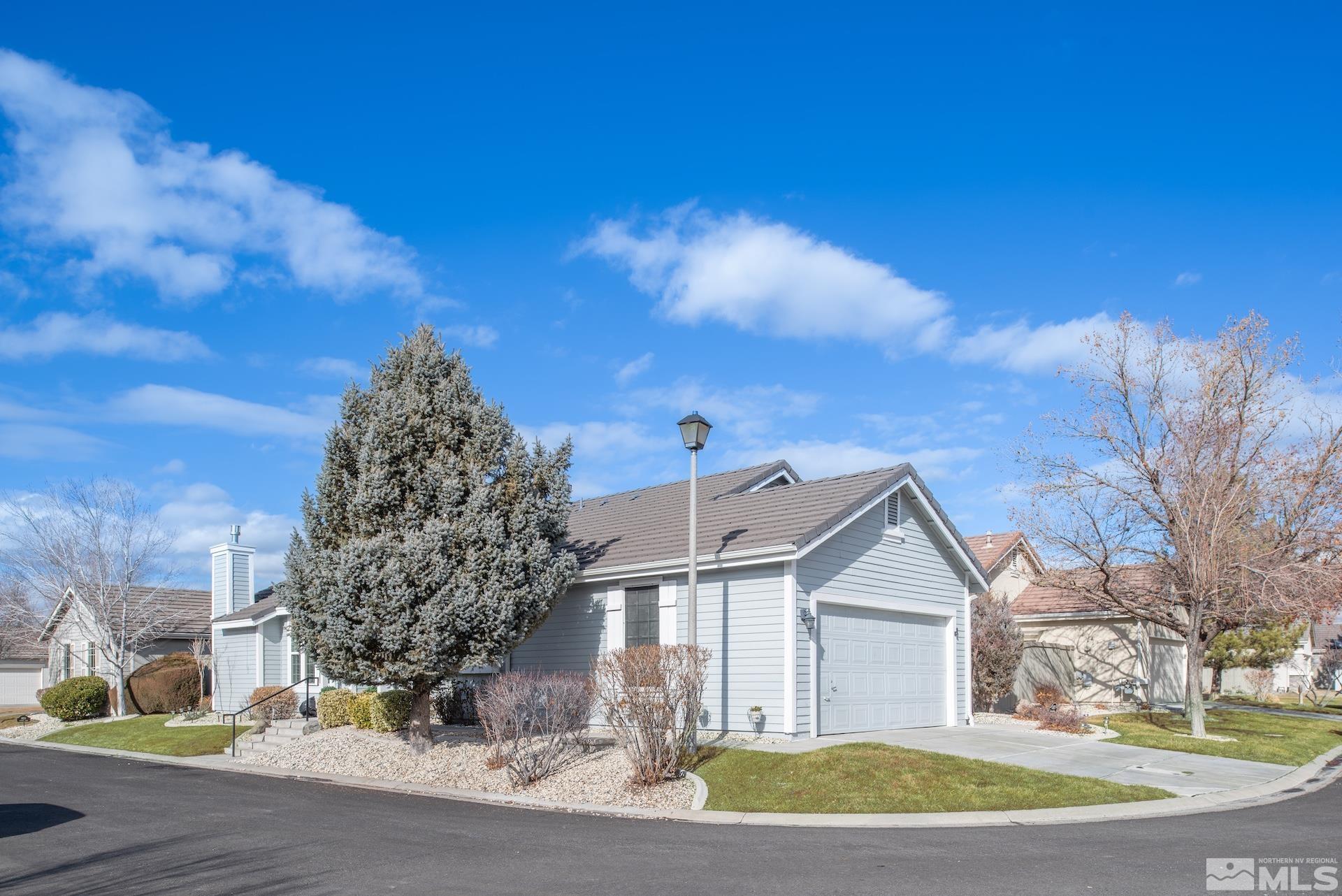 10175 Donner Peak Drive Reno, NV 89521 - Photo 4 of 35 a front view of a house with a yard