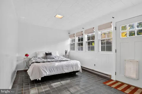 a bedroom with a bed and a window