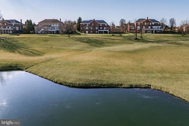 a living room with furniture fireplace and a large window