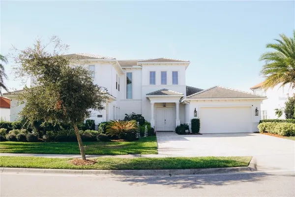 a front view of a house with a garden and plants