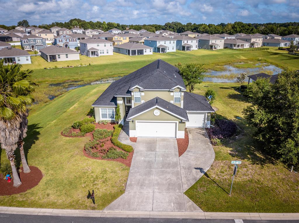 an aerial view of a house with a yard
