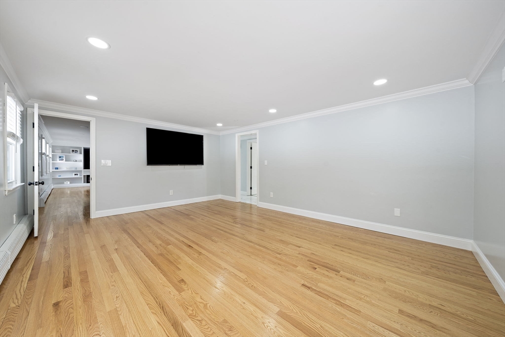 10 Dowd Avenue Wareham, MA 02571 - Photo 17 of 42 a view of an empty room with wooden floor and a kitchen