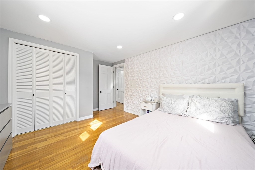 10 Dowd Avenue Wareham, MA 02571 - Photo 32 of 42 a bedroom with a large bed and a chandelier