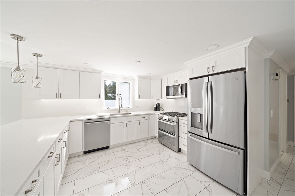 10 Dowd Avenue Wareham, MA 02571 - Photo 6 of 42 a kitchen with white cabinets and white appliances
