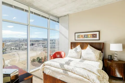 a bedroom with a bed and glass window