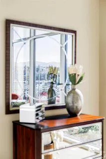 a living room with a table and a potted plant