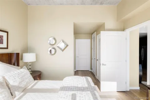 a bedroom with a bed and a mirror