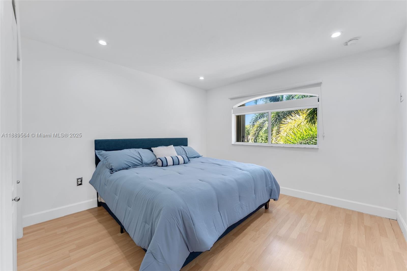 21059 Southwest 90th Place Cutler Bay, FL 33189 - Photo 12 of 20 a bedroom with a bed and a window