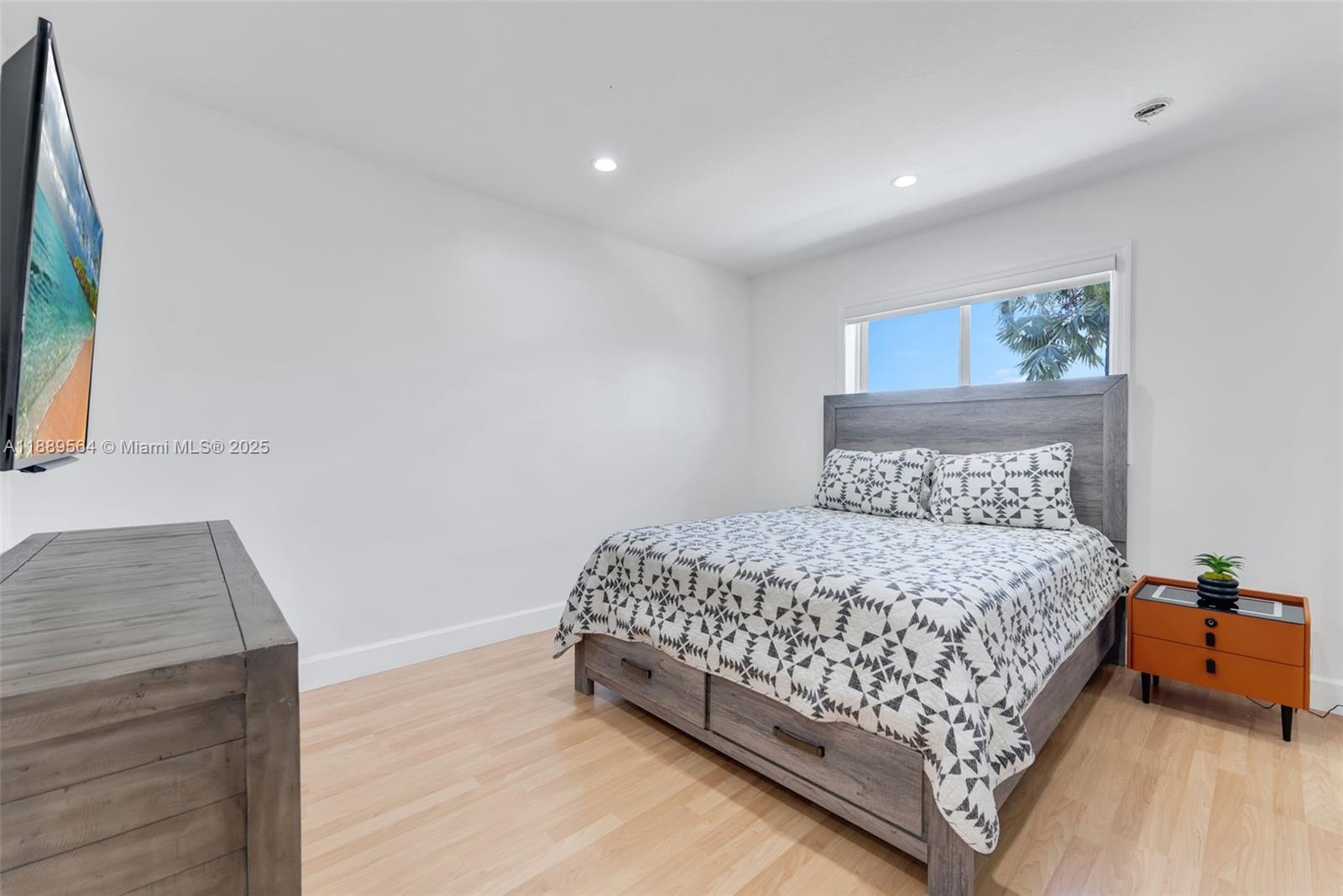 21059 Southwest 90th Place Cutler Bay, FL 33189 - Photo 13 of 20 a bedroom with a bed and window