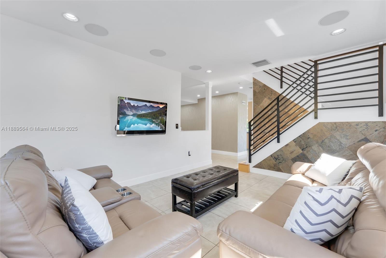 21059 Southwest 90th Place Cutler Bay, FL 33189 - Photo 4 of 20 a living room with furniture and a flat screen tv