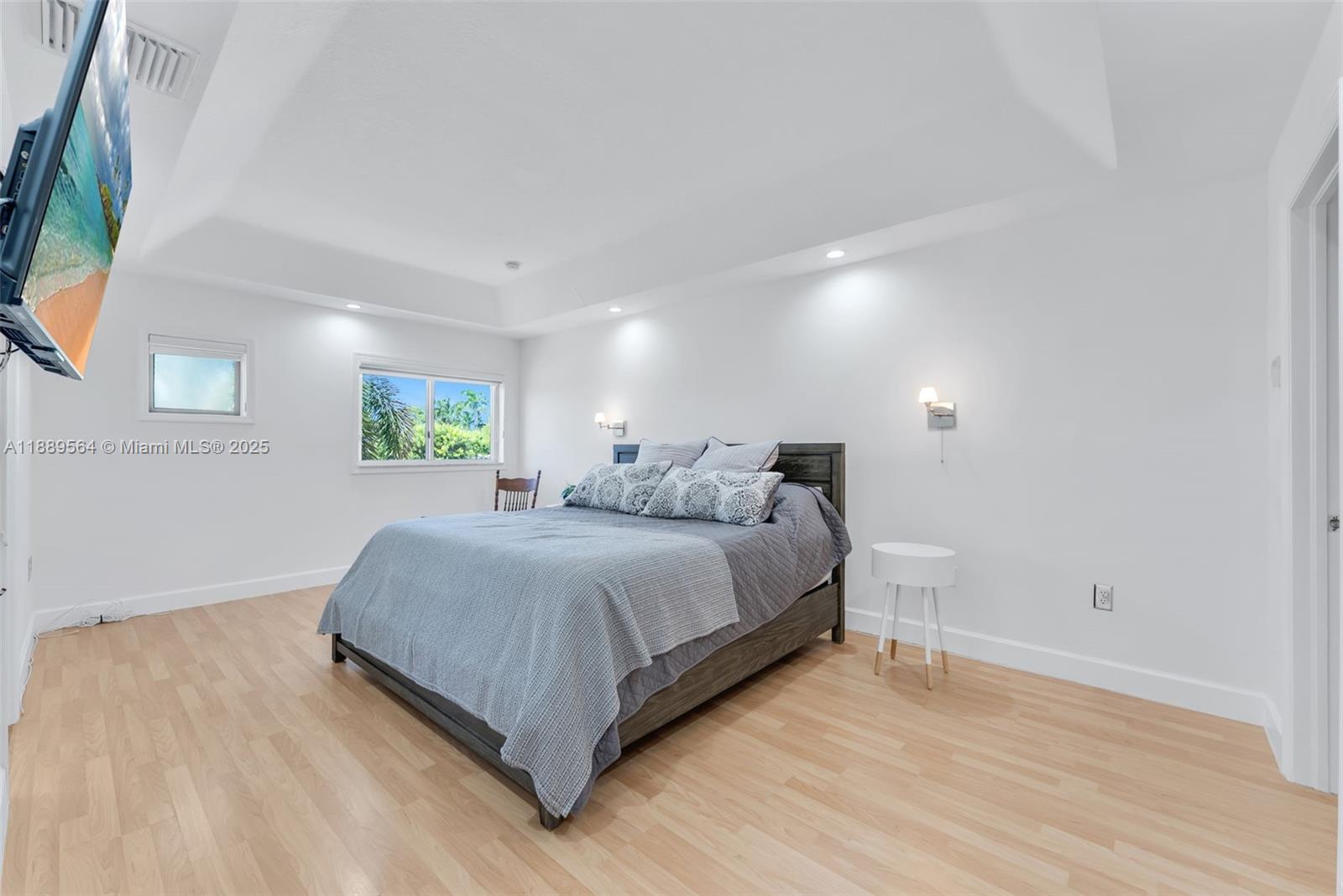 21059 Southwest 90th Place Cutler Bay, FL 33189 - Photo 9 of 20 a spacious bedroom with a bed and a flat screen tv