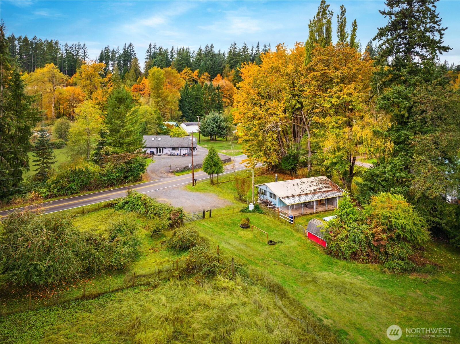 921 Russell Road Snohomish, WA 98290 - Photo 4 of 15 a view of a yard with swimming pool and trees in the background